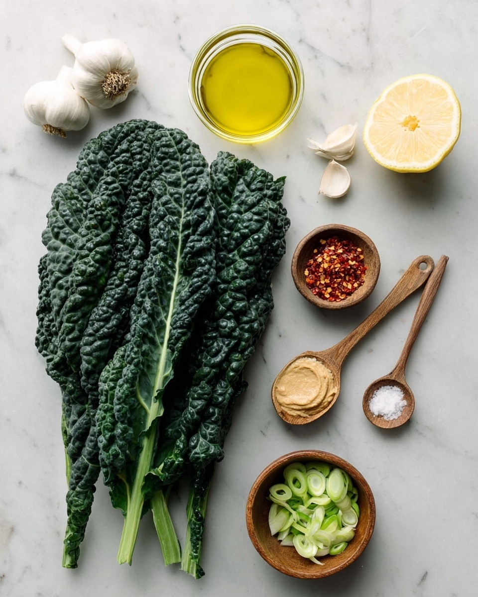 The image shows fresh dark green kale leaves stacked on the left side with a bumpy texture and thick stems. To the right are two whole white garlic bulbs at the top left, a clear glass bowl with yellow olive oil in the center, and a white halved lemon showing its juicy, pale yellow inside on the top right. Below the lemon is a small wooden bowl filled with red chili flakes. A wooden spoon with a light brown paste, likely miso, is placed next to a smaller wooden spoon holding fine white salt. At the bottom right, there is another small wooden bowl filled with sliced green onions. All items are arranged neatly on a white marbled surface. Photo taken with an iphone --ar 4:5 --v 7
