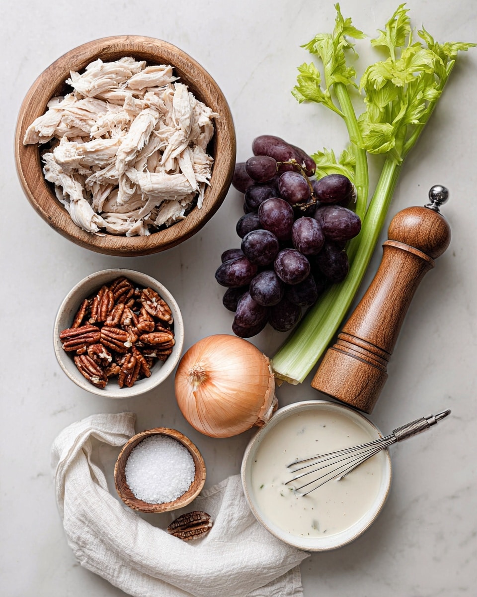 The image shows shredded white chicken piled in a wooden bowl positioned at the top left. Below it, there is a small white bowl filled with brown pecans. To the right of the pecans, two green celery stalks with leaves lie horizontally. Next to the celery, a whole light brown onion rests on the white marbled surface. Above the onion and celery, a bunch of dark purple grapes sits on the right side of the image. To the right of the grapes, a wooden pepper grinder stands tall, and below it, a small wooden bowl filled with white salt rests on a white cloth napkin. At the bottom right, a white bowl filled with light creamy dressing or sauce has a small metal whisk inside. The whole setup is on a white marbled surface and looks fresh and clean. Photo taken with an iphone --ar 4:5 --v 7