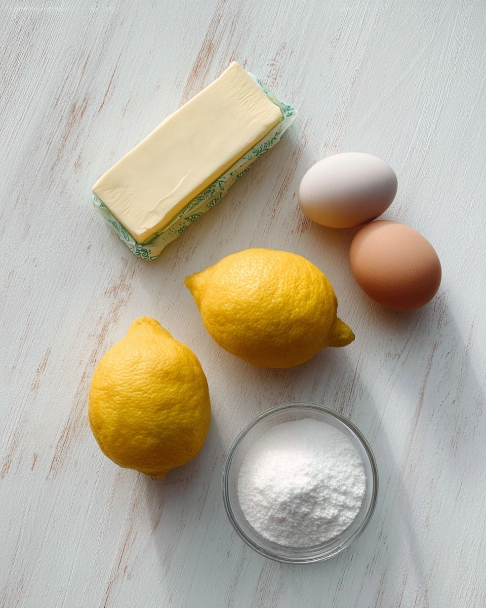 Two bright yellow lemons with rough texture sit on a white marbled surface near a rectangular stick of butter in cream and green paper wrapping. Below them, there are two eggs, one light brown and one pale light gray, placed side by side. In the lower right corner, a small clear glass bowl holds a fine white powder, likely sugar. The items are spaced with a soft natural light shining on them. photo taken with an iphone --ar 4:5 --v 7