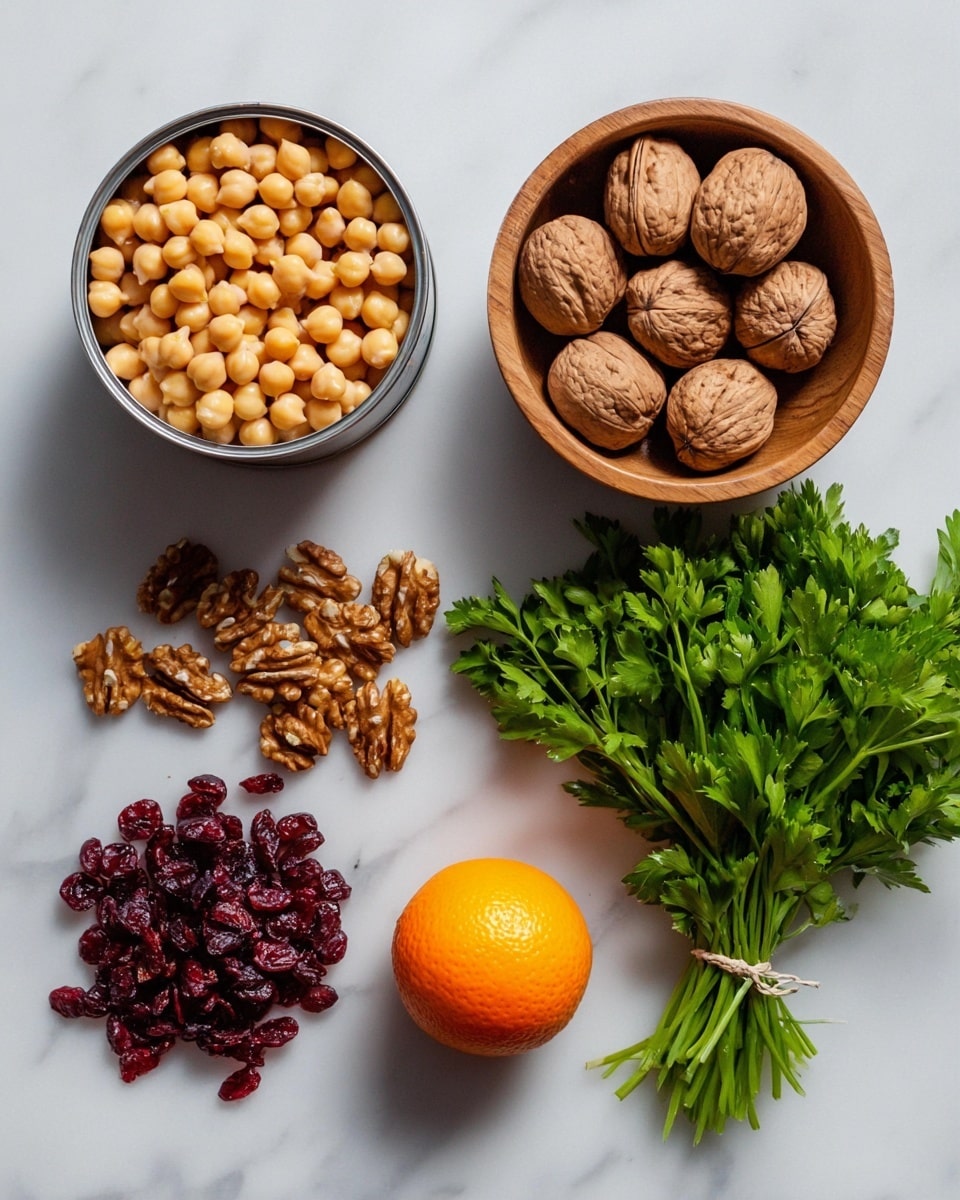 Two open cans filled with light yellow chickpeas sit at the top left, next to a round wooden bowl full of whole brown walnuts placed in the center top. Below the cans, there is a small pile of dark red dried cranberries. To the right of the cranberries, a single bright orange is positioned near the center bottom. On the far right, a bunch of fresh green parsley with stems tied together lies flat. All items rest on a white marbled surface. photo taken with an iphone --ar 4:5 --v 7