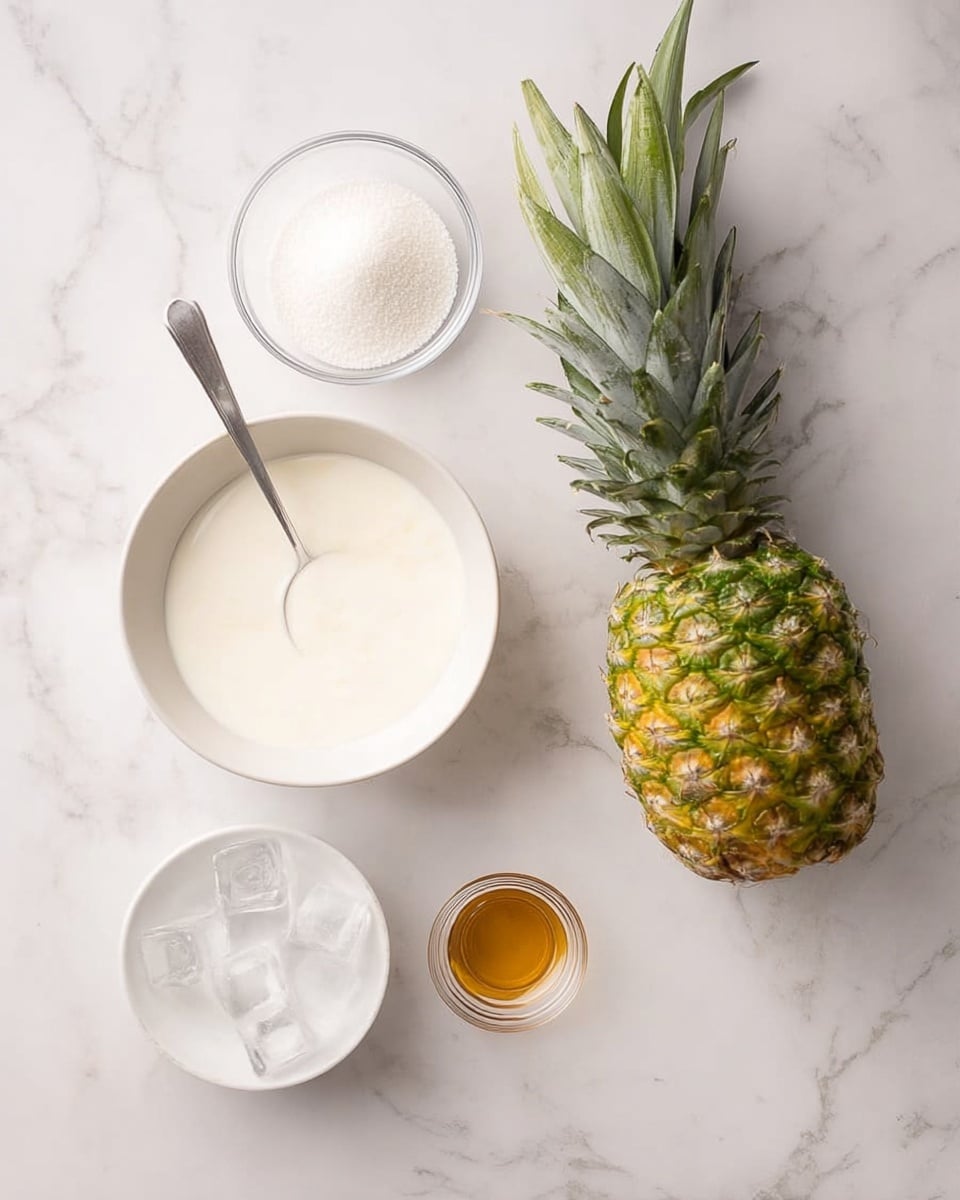 The image shows a white bowl with a spoon inside, filled with a smooth white liquid, placed on a white marbled surface. To the right of the bowl is a whole green and yellow pineapple with spiky leaves. Above the bowl is a small clear glass bowl filled with white granulated sugar. Below the white bowl is another white bowl filled with clear ice cubes. To the right of the ice bowl is a small clear glass cup with a small amount of golden-brown liquid inside. All items are neatly arranged on the white marbled surface with soft natural light coming from above. Photo taken with an iphone --ar 4:5 --v 7