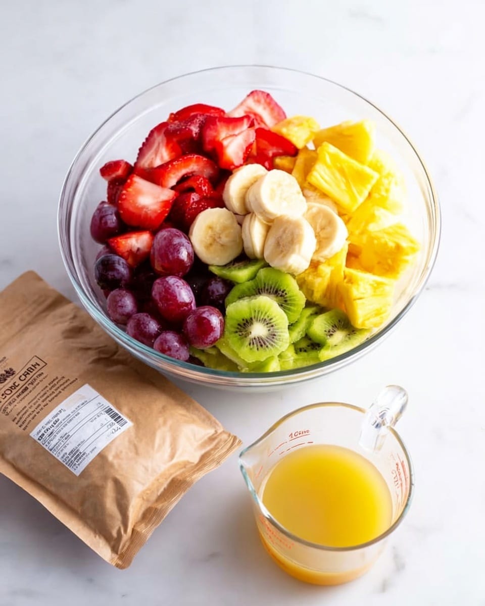 A clear glass bowl filled with six layers of different fruits arranged separately: red sliced strawberries on the top left, purple grapes just below them, yellow pineapple chunks on the top right, smaller yellow-orange pieces of another fruit next to the pineapple, sliced green kiwi at the bottom, and banana slices in the center. In front of the bowl, there is a white bag of sugar, a brown paper package, and a clear measuring cup with yellow juice. The items rest on a white marbled surface. Photo taken with an iphone --ar 4:5 --v 7