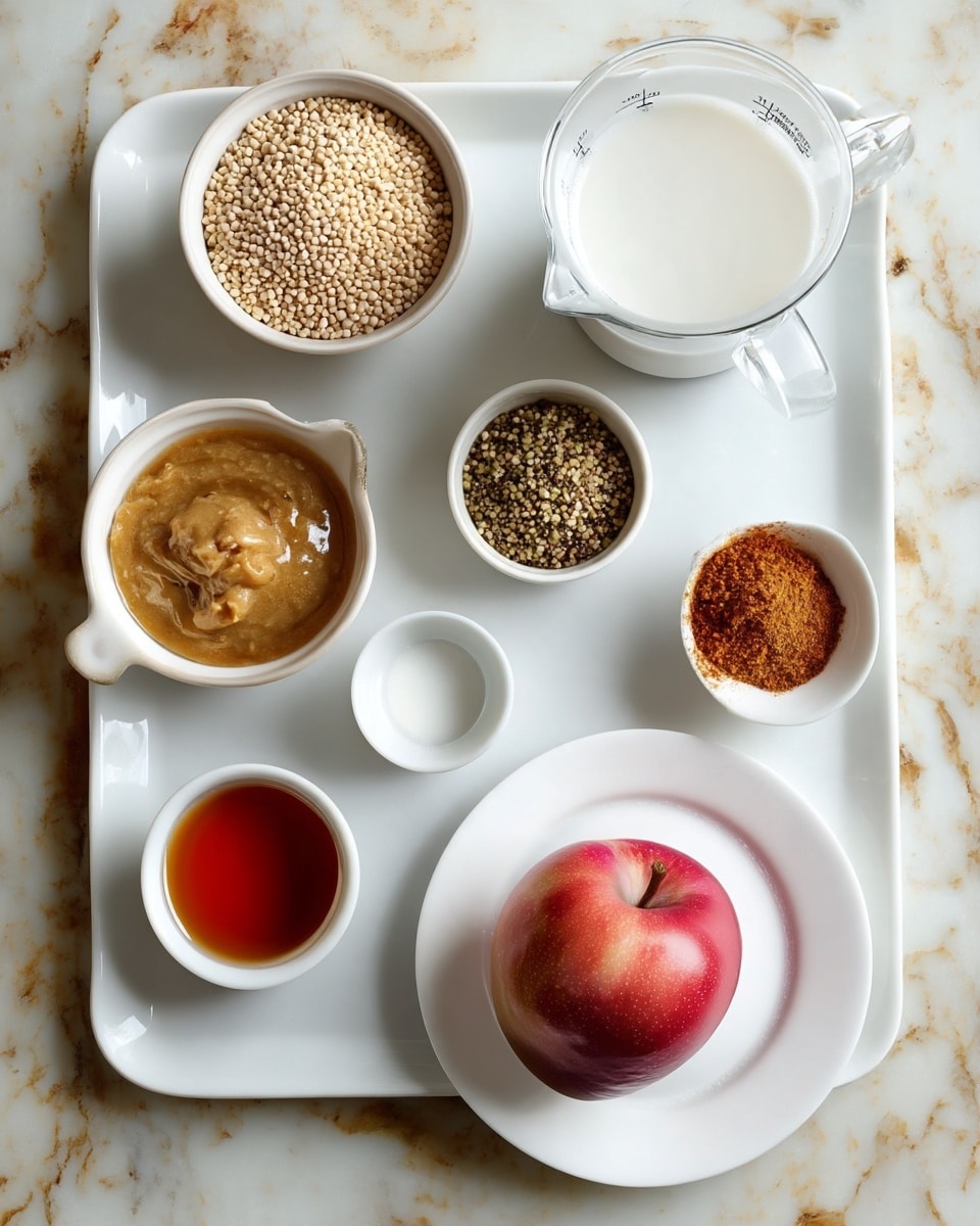 The image shows nine small white bowls and dishes arranged on a white marbled tile surface with some brown spots. The top left bowl holds small round beige grains, the bowl below it contains small greenish-brown seeds. To the right of these, there is a clear measuring jug filled with white liquid. Below the jug are two small white bowls, one with a light brown powder and the other with a darker brown powder. To the left of these is a small white pitcher with a smooth light brown paste. Below it is a small dish with clear liquid and a small white bowl with reddish-brown powder. In the bottom center of the image, a single red apple sits on a white plate. The photo taken with an iphone --ar 4:5 --v 7