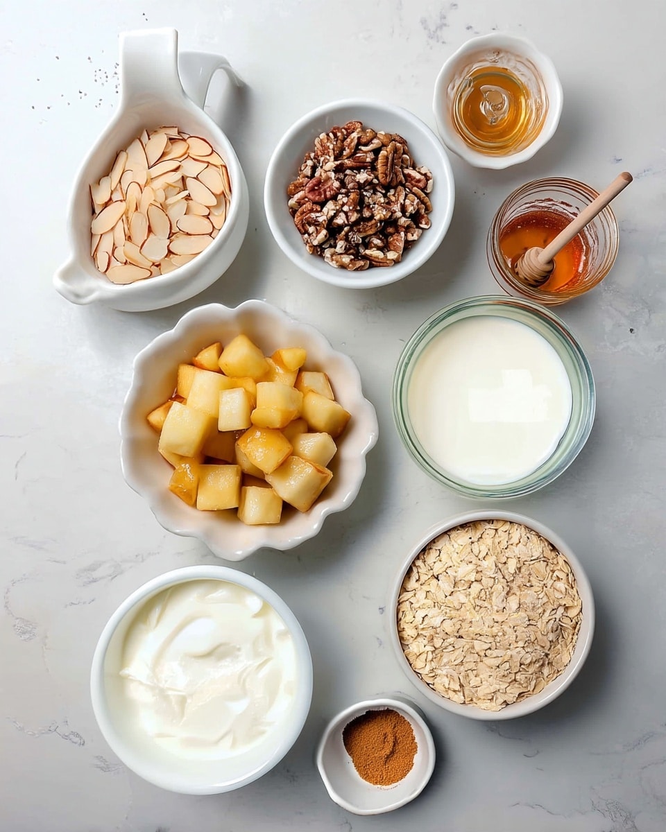 A top-down view of eight small white dishes and bowls arranged on a white marbled surface, each holding different ingredients: sliced light beige almonds in a small bowl with a handle at the top left, tiny black chia seeds in a small dish below it, crushed light brown pecans in a round bowl in the center, golden honey with a wooden honey dipper in a glass jar to the right, pale cubed apples soaked in syrup in a scalloped white bowl at the bottom left, smooth white yogurt in a round bowl below the apples, light brown cinnamon powder in a tiny white dish at the bottom right, fresh white milk in a glass bowl above the oatmeal, and light beige rolled oats filling a larger bowl at the bottom right corner photo taken with an iphone --ar 4:5 --v 7